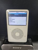 Front view of white 30GB iPod powered on in Sony dock