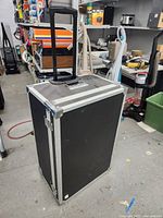 Full view of closed flight case with telescopic handle extended