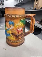 Front view showing figures in relief and handle shape