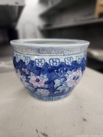 Side view showing blue and white floral decoration on planter