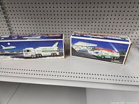 Two boxed Hess toys on shelf