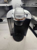Front view of Keurig brewer showing overall design and missing drip tray