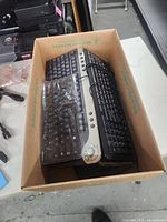 Box containing multiple keyboards viewed from side