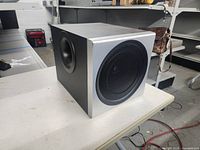 Three-quarter view of Logitech cube subwoofer on table