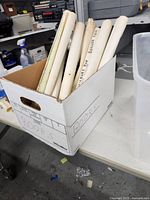 Box showing several rolled maps