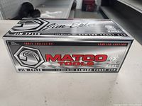 Front and side of boxed Matco Tools die-cast Camaro Funny Car
