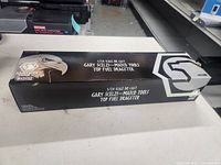 Closed retail box showing branding and scale