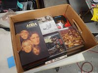 Top view of open cardboard box showing ABBA box set and several CD jewel cases