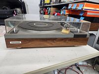 Front view of Pioneer PL-11D turntable showing wood plinth and dust cover