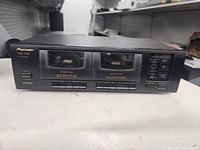 Front view of Pioneer CT-W103 showing dual cassette wells and controls