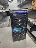 Front view showing six LG drives, controller panel, ProDuplicator branding