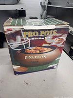 Box front showing Pro Pots Football Slow Cooker branding and food image