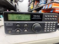 Front view showing Radio Shack DX-394 receiver display, controls and keypad