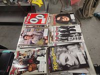 Tabletop view of multiple Rolling Stone magazine issues displaying various covers
