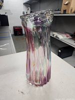 Full front view of tall multicolour ribbed glass vase