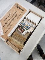 Cigar box filled with envelopes and stacks of stamps