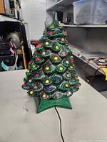 Front view of ceramic Christmas tree showing bulbs and base