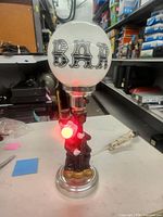 Full lamp showing clown base, metal neck, BAR globe shade