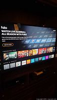TV turned on displaying Fubo TV streaming service interface with clear text and icons visible.
