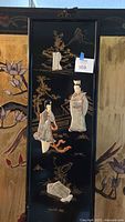 Full view of the black and gold Asian scenery wall panel with three 3D onlay figures attached.