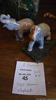 Photo showing both ceramic elephant figurines with a note listing their approximate dimensions (3.5" x 4") and quantities (2).