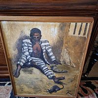 Framed oil painting on canvas showing a prisoner in striped prison uniform sharing a meal in a cell, signed by Thomas Sparks.