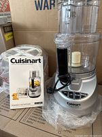 Photo showing the Cuisinart Prep 11 Plus food processor with control panel and included instruction and recipe booklet.