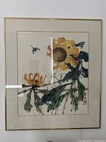 Full view of framed sunflower print under glass showing two sunflowers and a bee with calligraphy signature.