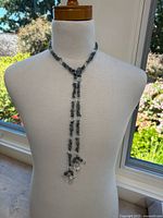 Front view of the handmade aquamarine chip necklace on a mannequin, showcasing the draped double strand and wrap clasp style.