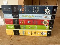 Photo of five Doctor Proctor's Fart Powder paperback books stacked to show titles and colorful spines