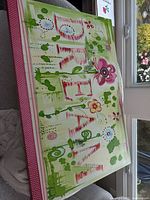 Full view of the stretched canvas art print showing the word 'DREAM' with green, pink, red, and white colors and floral embellishments.