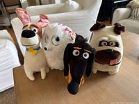 Group of four medium size plush toys from The Secret Life of Pets, two dogs, one lamb, one dachshund.