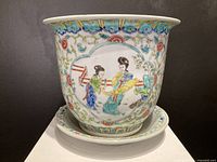 Front view of jardiniere and saucer, showing painted figures and floral designs