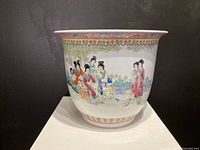 Full view of the jardiniere showing the hand-painted scene of Chinese women in traditional clothing against a garden backdrop with decorative border patterns at rim and base.