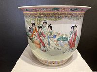 Front view showing painted scene of women in garden with detailed attire and hairstyles, decorative patterned rim and base border.