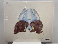 The stonecut and stencil art print shows two brown walruses facing each other with a blue bird centered behind them, rendered on cream paper.
