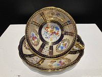 Tea cup stacked in saucer, showing overall design and gold edging