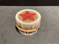 Overall view of round quill and birch bark container with red star on lid.