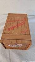 Wooden crate style box with 'This End Up Fragile' printed in red on top and marked with 'A Christmas Story' logos.