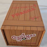 Box packaging resembling a wooden crate labeled A Christmas Story with Fragile text