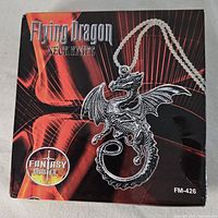 Original box of the Flying Dragon Neck Knife pendant with chain, showing the branding and design.