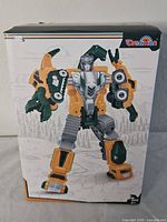 Box front showing Dreamon robot in humanoid robot form with yellow, green, grey colors.