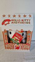 Hello Kitty and Friends hugger pillow in original gingerbread house themed box with stars and gingerbread men decor