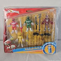 Front view of unopened Imaginext Power Rangers Battle Pack with four figures and accessories in original packaging.