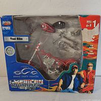 Front view of boxed Joyride American Chopper Tool Bike diecast model kit showing packaging and partially assembled parts.