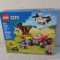 Front of LEGO City box showing the set with ATV, drone, tree, and animals.
