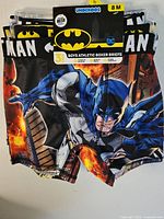 Photo of boys' Batman boxer briefs 3 pack, size 8M, showing front with Batman character and logo prints.