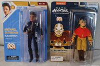 View of both action figures side by side in original retail packaging showing character names and branding.
