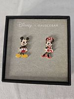 Pair of Disney x BaubleBar earrings in original box showing Mickey and Minnie Mouse designs