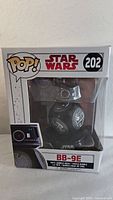 Front view of sealed Funko Pop box showing BB-9E figure with the number 202 and Star Wars logo.